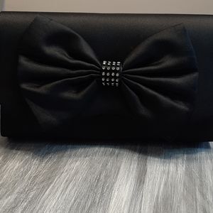 Black bow clutch by Avon